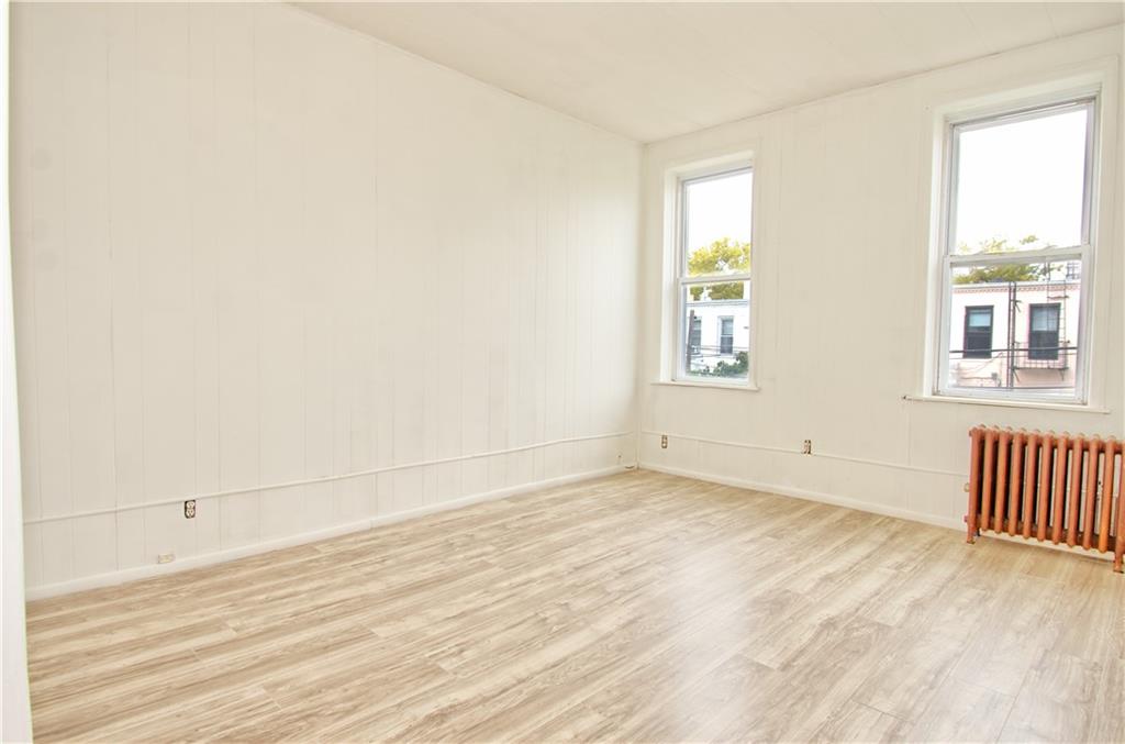 8800 19th Avenue Brooklyn, NY 11214 - Photo 5 of 26 an empty room with wooden floor and windows