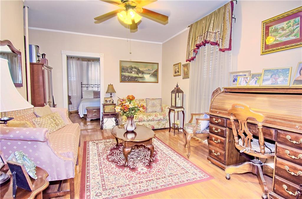 8800 19th Avenue Brooklyn, NY 11214 - Photo 7 of 26 a living room with furniture and a rug