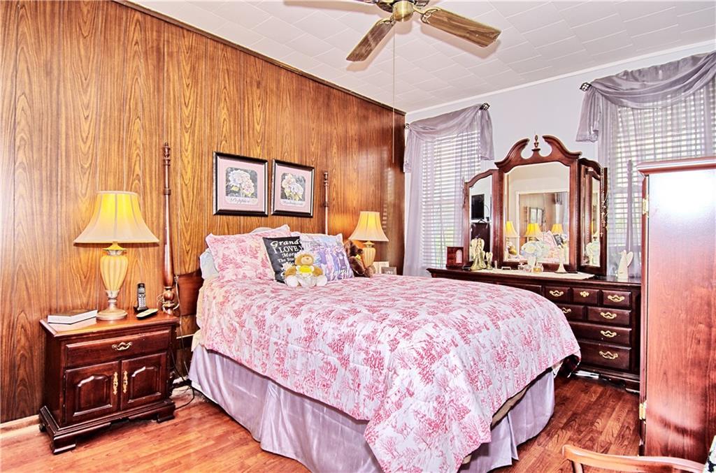 8800 19th Avenue Brooklyn, NY 11214 - Photo 9 of 26 a bedroom with a bed and a chandelier