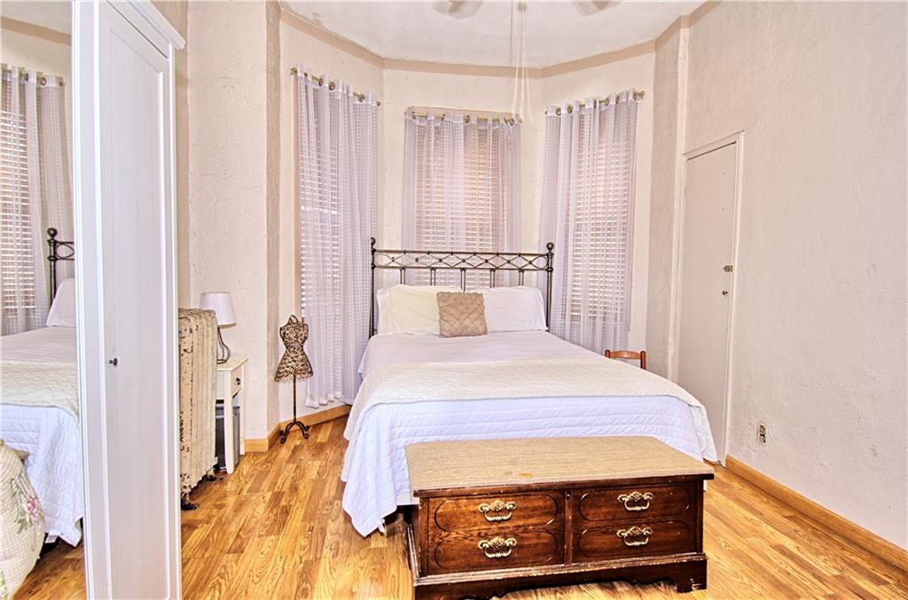 8800 19th Avenue Brooklyn, NY 11214 - Photo 10 of 26 a bedroom with a bed and a dresser