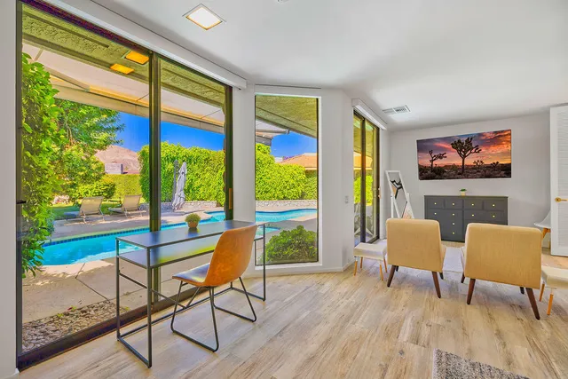 a living room with furniture and a floor to ceiling window