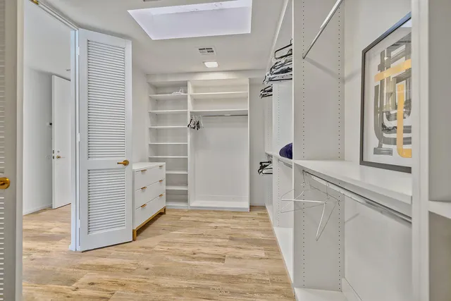 a view of a walk in closet and bedroom