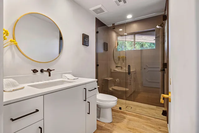 a bathroom with a sink toilet and shower