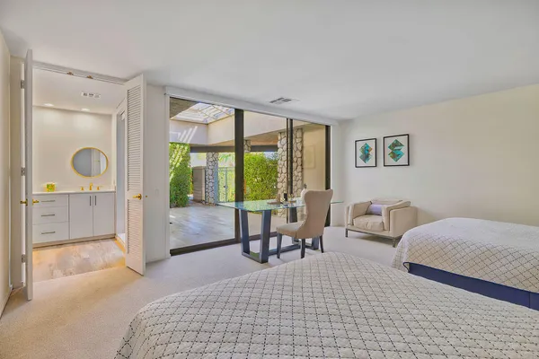 a bedroom with a bed and a large window