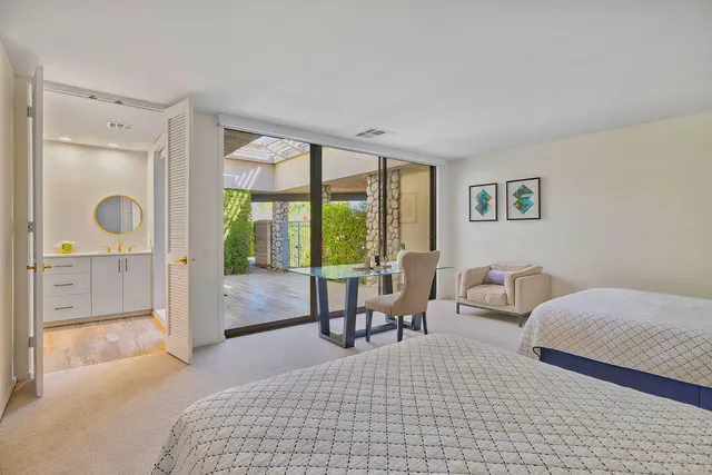 a bedroom with a bed and a large window