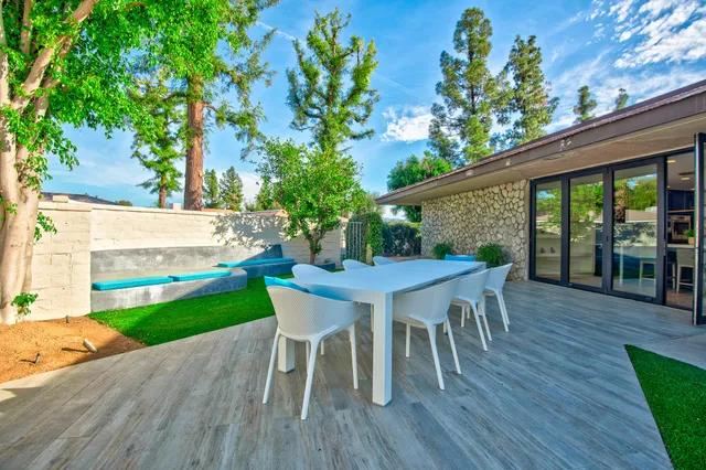 a dining room with furniture and wooden floor