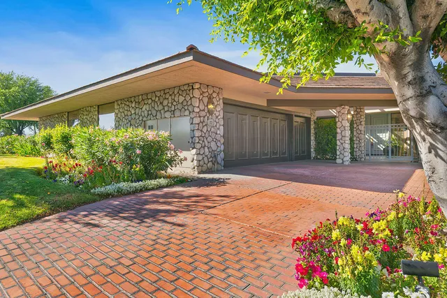 a front view of a house with a yard and a garage