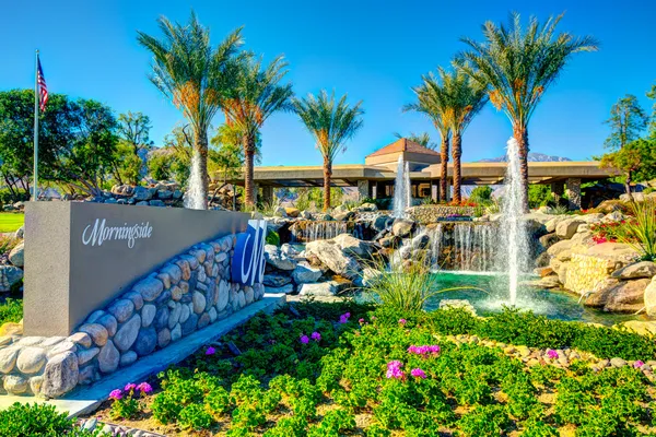 a view of a house with large trees and swimming pool