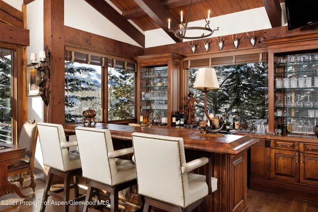 a dining table with chairs and chandelier