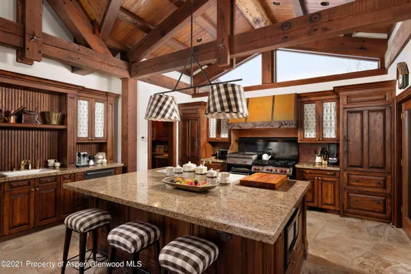 a kitchen with a sink appliances and cabinets