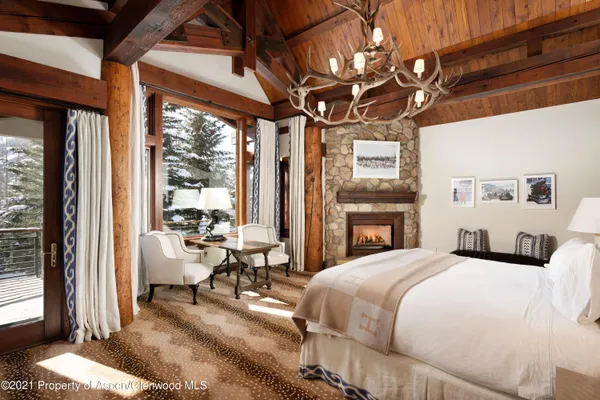 a bedroom with a bed couch and a large window