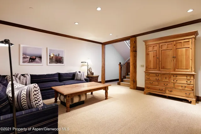 a living room with furniture and a dresser