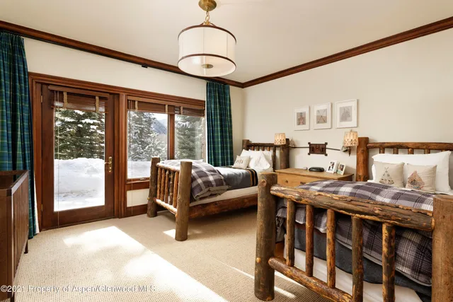 a bedroom with furniture and large windows