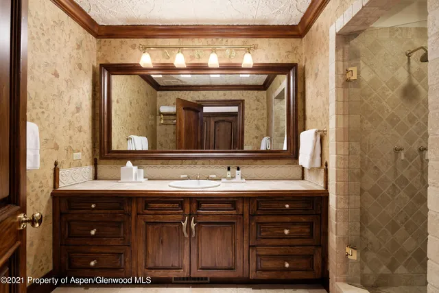 a bathroom with a double vanity sink and a mirror