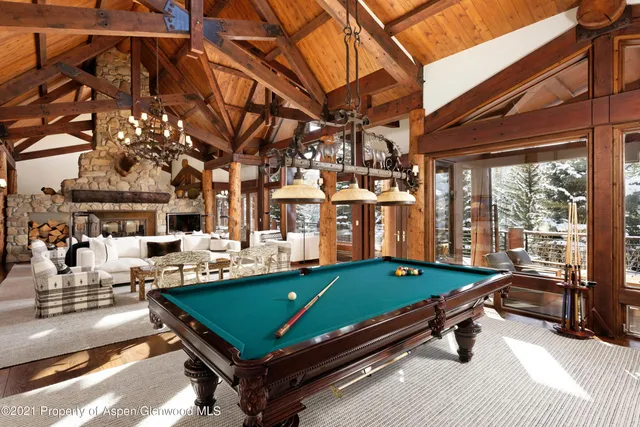 a room with pool table table and chairs
