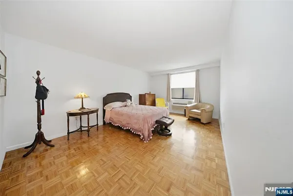 a bedroom with a bed and a chair