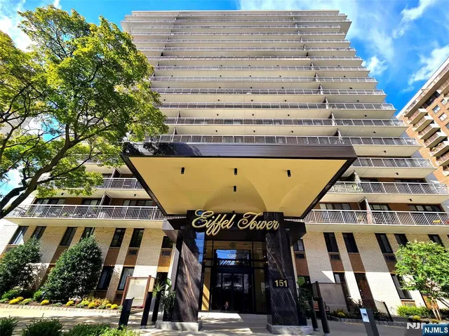 a front view of a building with a garden