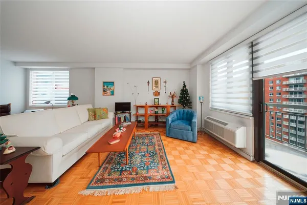 a living room with furniture a rug and a large window