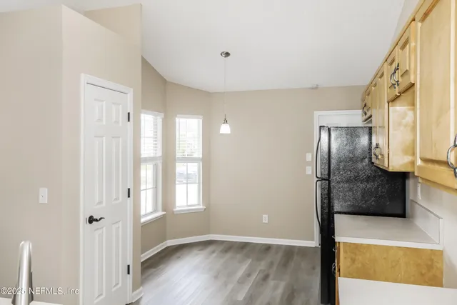a view of a hallway with wooden floor and staircase
