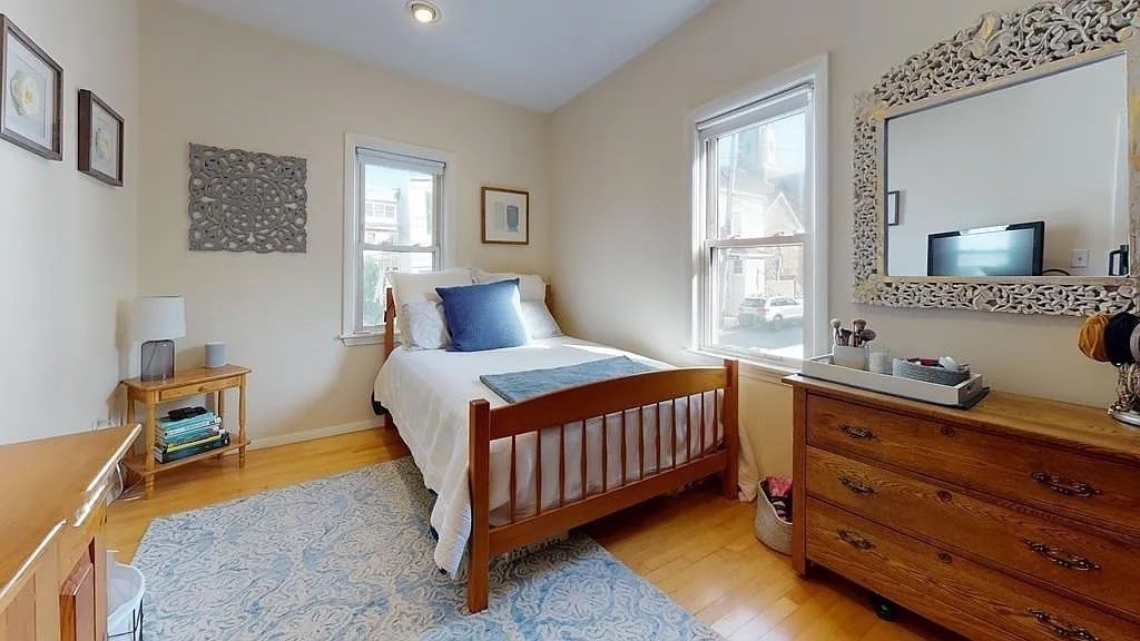 22 North Mead Street Boston, MA 02129 - Photo 2 of 7 a bedroom with a bed and wooden floor