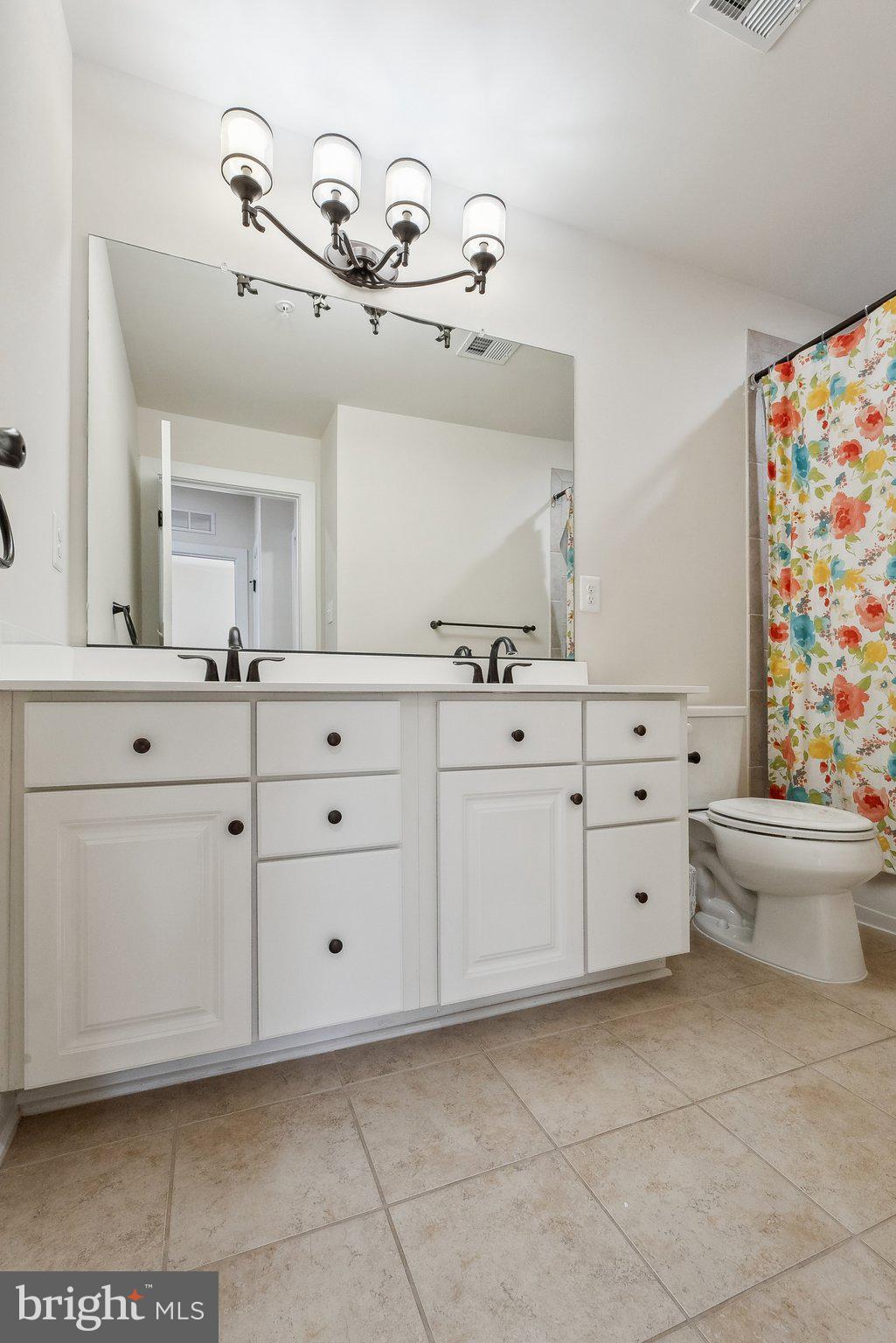 3178 Yeager Drive Herndon, VA 20171 - Photo 20 of 31 a bathroom with a sink a toilet and mirror