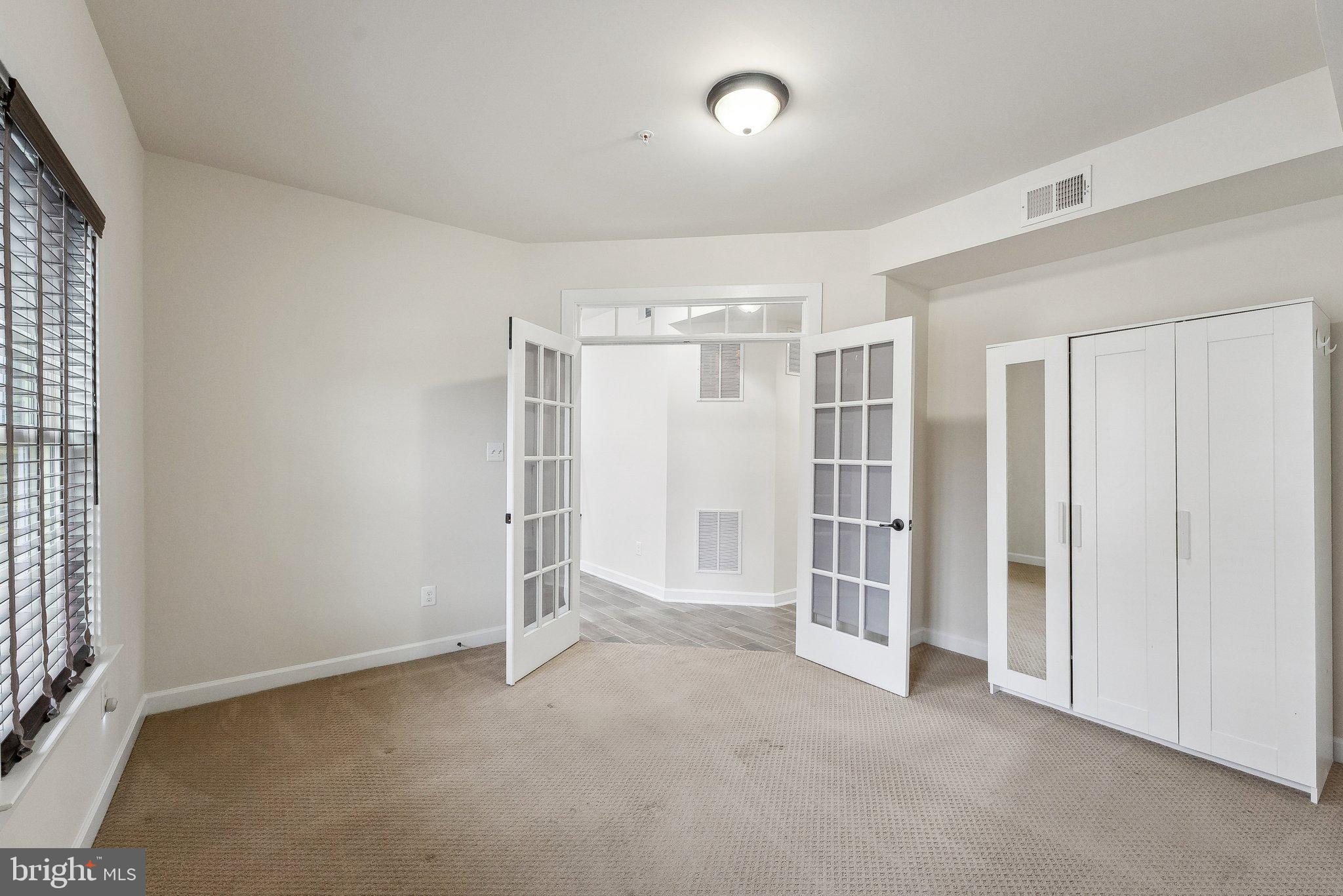 3178 Yeager Drive Herndon, VA 20171 - Photo 4 of 31 an empty room with a cabinet and mirrors