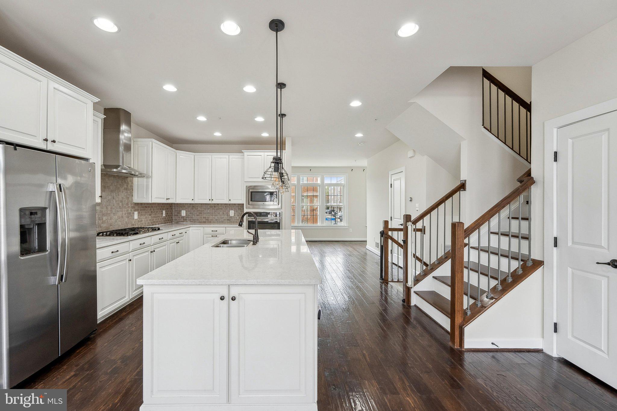 3178 Yeager Drive Herndon, VA 20171 - Photo 9 of 31 a kitchen with white cabinets sink and refrigerator