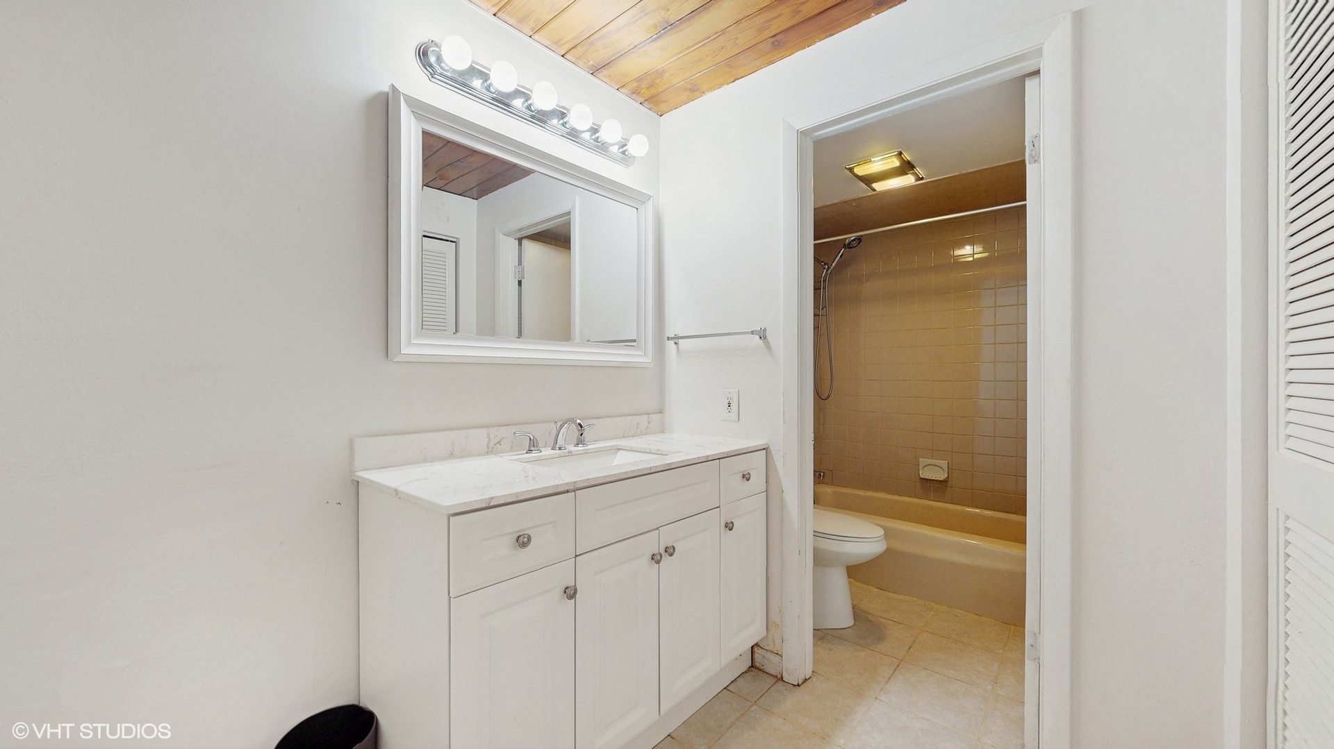 2306 Holiday Terrace, Unit 166 Lansing, IL 60438 - Photo 9 of 13 a bathroom with a toilet sink and mirror