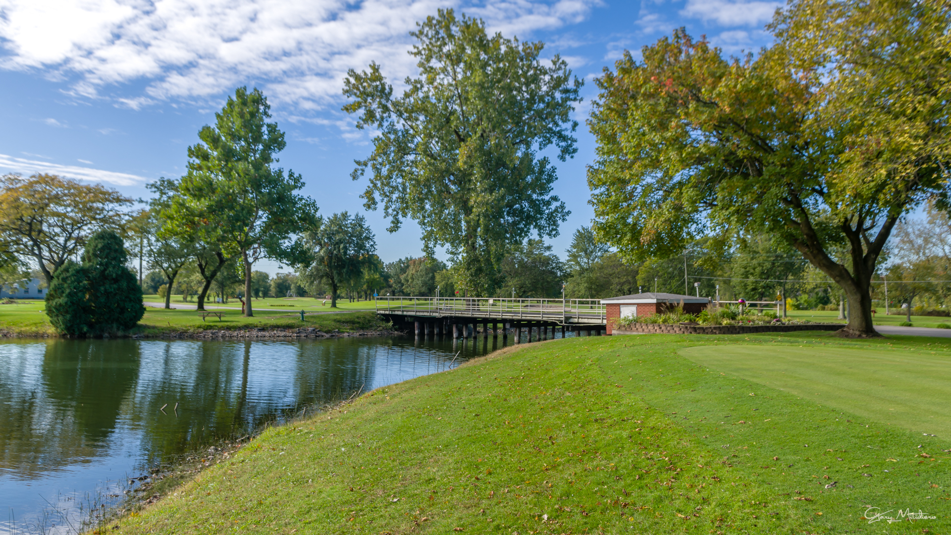 3680 186th Street, Unit 303 Lansing, IL 60438 - Photo 20 of 23 a view of a lake with a house in the background