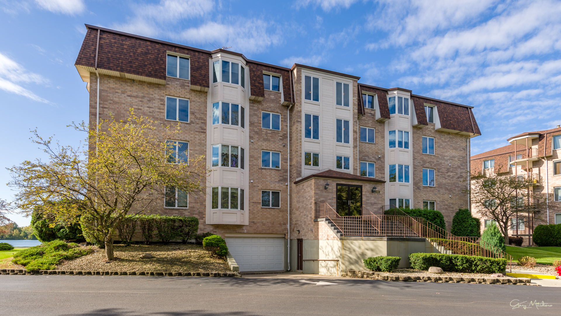 3680 186th Street, Unit 303 Lansing, IL 60438 - Photo 22 of 23 a front view of a residential apartment building with a yard