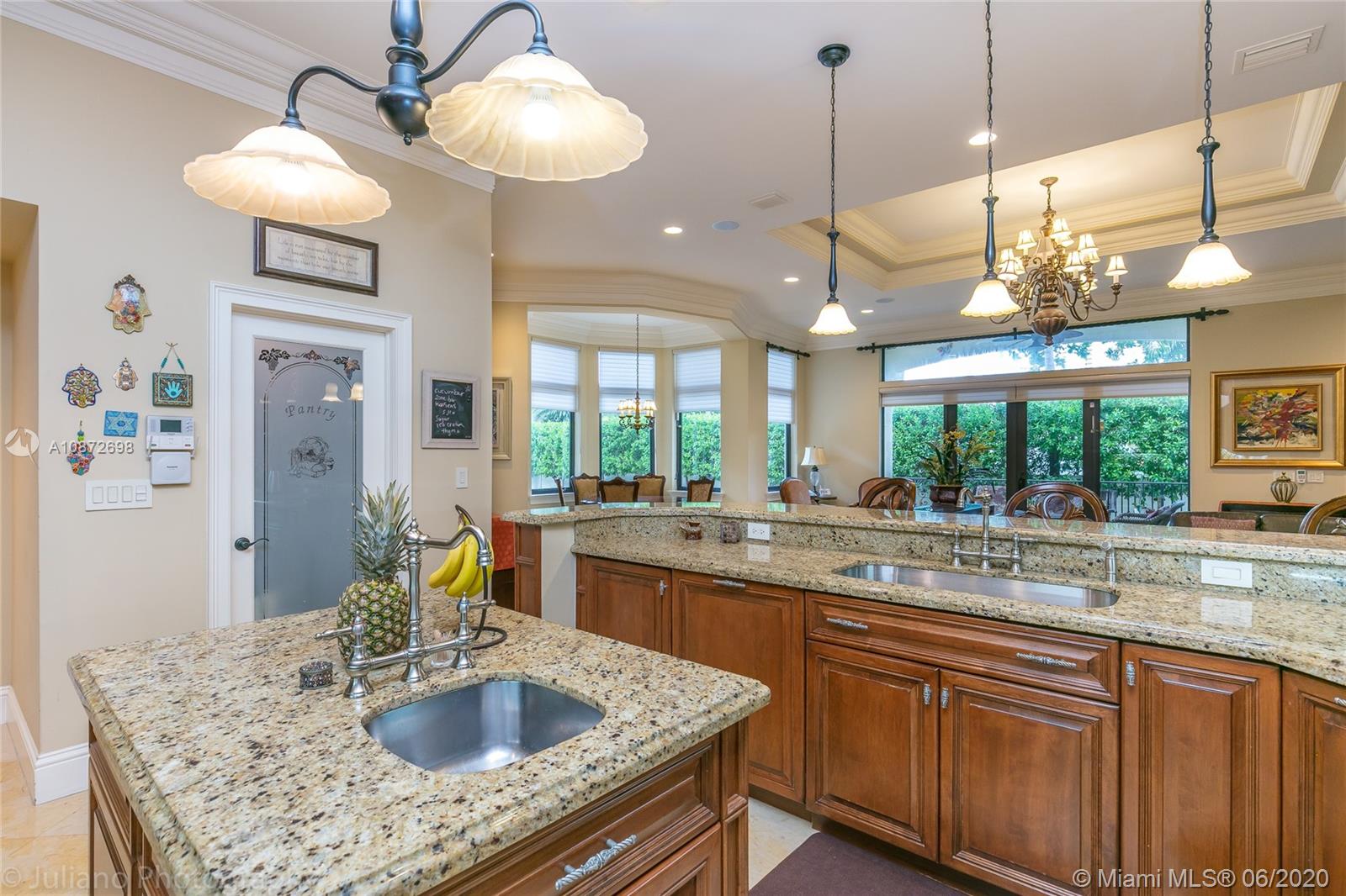 19141 North Bay Road Sunny Isles Beach, FL 33160 - Photo 16 of 42 a kitchen with a sink a counter space and chandelier