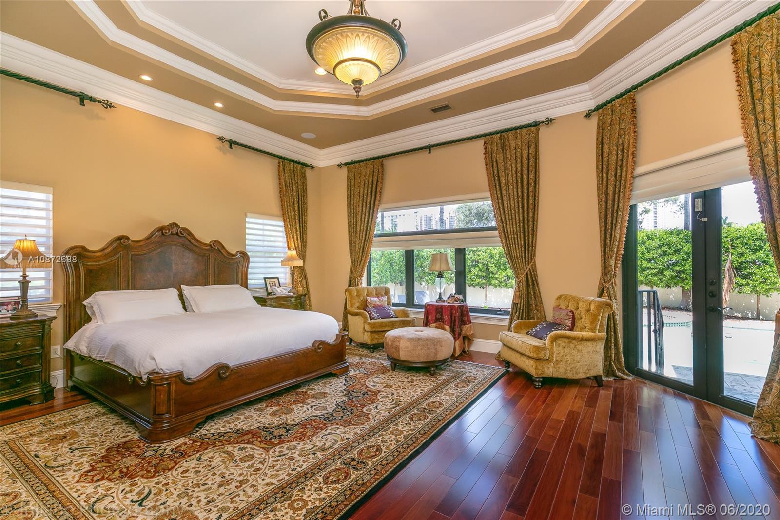 19141 North Bay Road Sunny Isles Beach, FL 33160 - Photo 19 of 42 a bedroom with a large bed and large windows