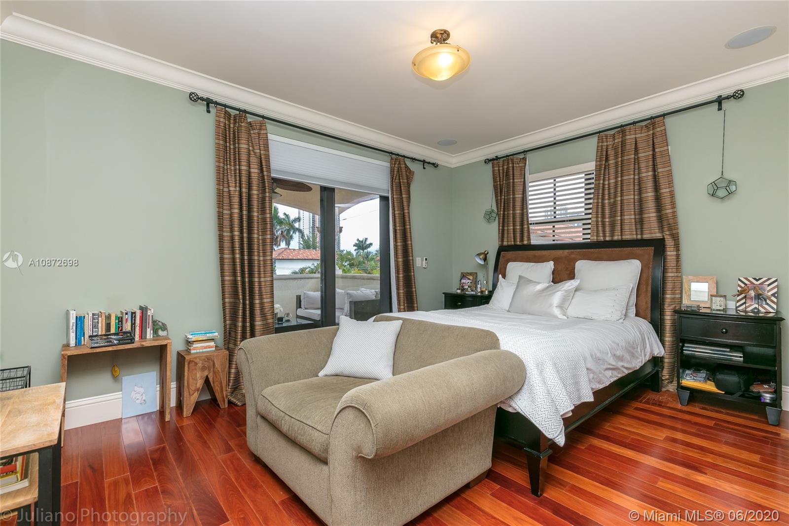 19141 North Bay Road Sunny Isles Beach, FL 33160 - Photo 28 of 42 a spacious bedroom with a bed and wooden floor