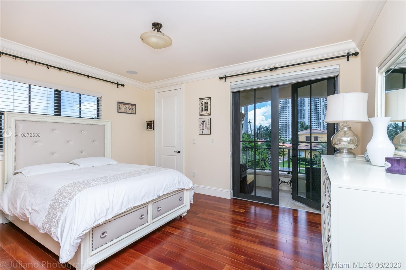 19141 North Bay Road Sunny Isles Beach, FL 33160 - Photo 30 of 42 a bedroom with a large bed and a window