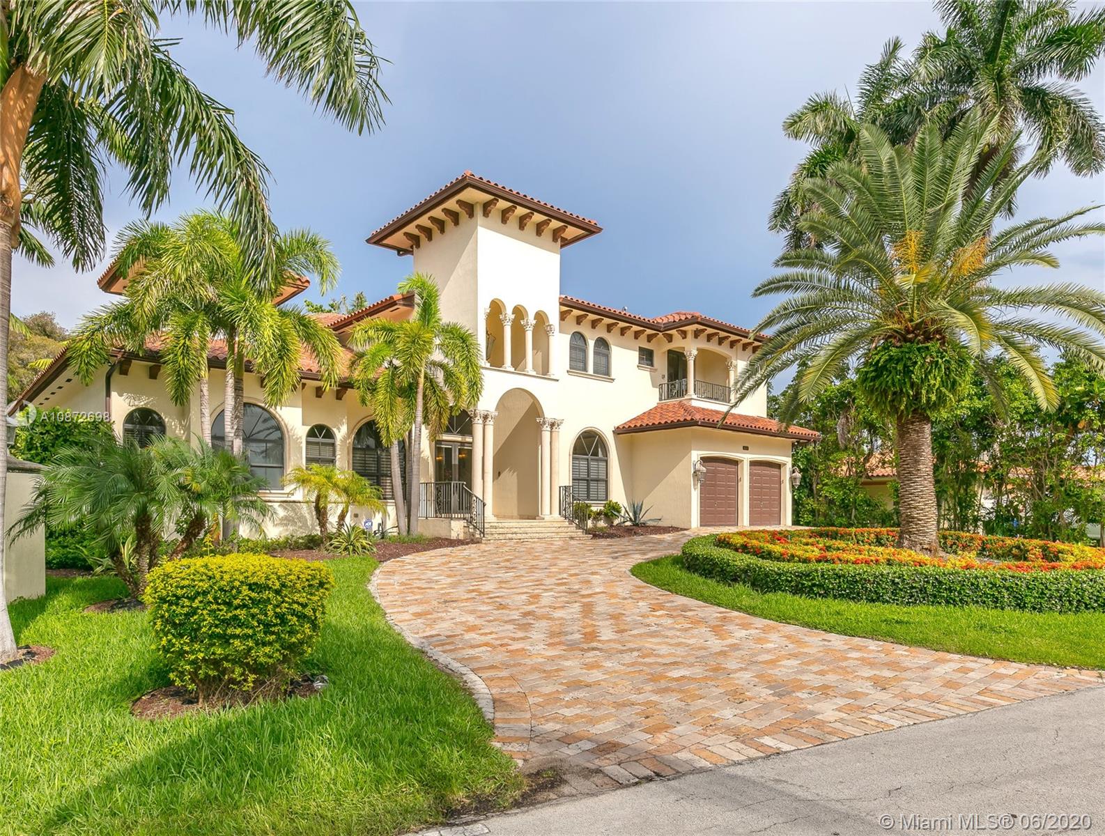 19141 North Bay Road Sunny Isles Beach, FL 33160 - Photo 3 of 42 a front view of a house with a yard and potted plants