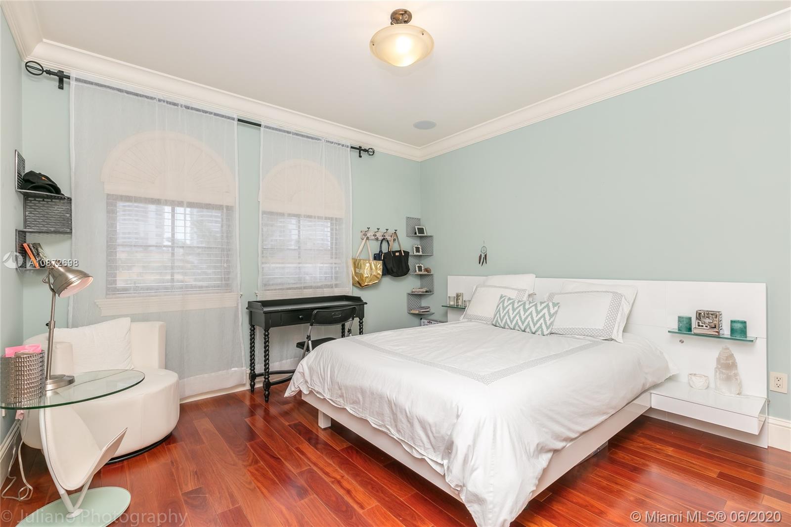 19141 North Bay Road Sunny Isles Beach, FL 33160 - Photo 32 of 42 a bedroom with a bed and a table