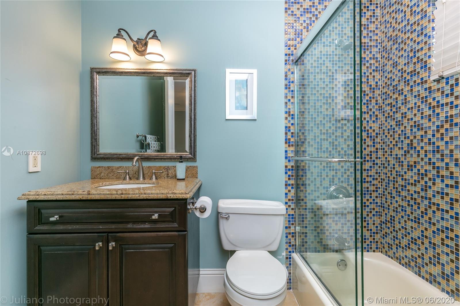 19141 North Bay Road Sunny Isles Beach, FL 33160 - Photo 38 of 42 a bathroom with a granite countertop sink toilet and mirror