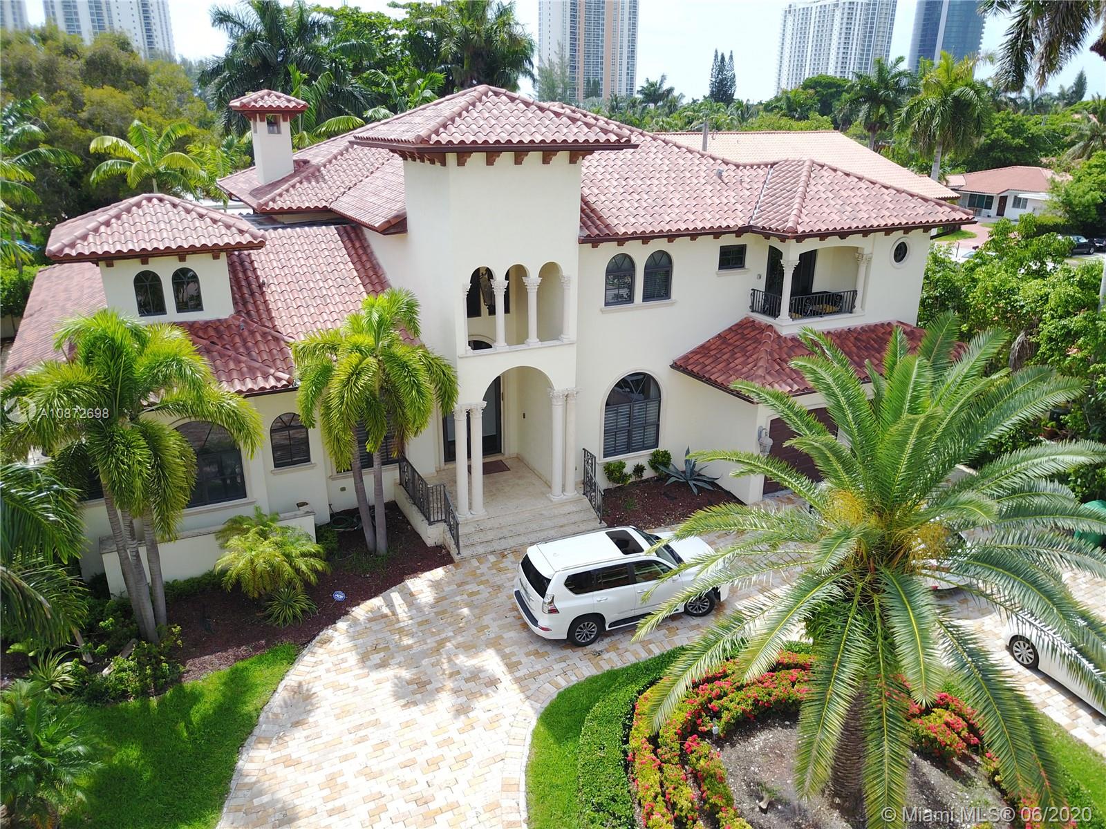 19141 North Bay Road Sunny Isles Beach, FL 33160 - Photo 40 of 42 a view of a patio with table and chairs under an umbrella