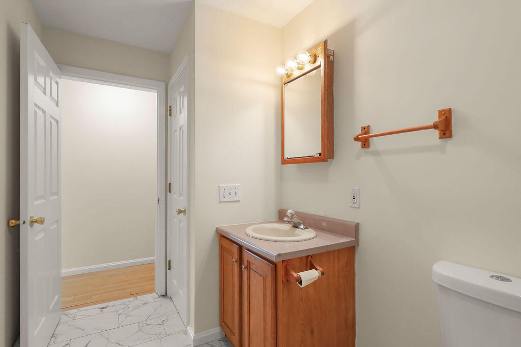 75 Edgewater Road Mashpee, MA 02649 - Photo 26 of 78 a bathroom with a sink and a mirror