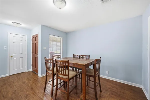 a view of a dining room with furniture and wooden floor