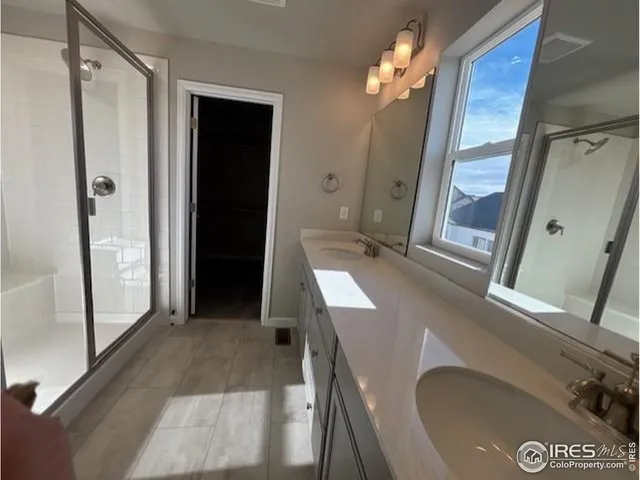 a bathroom with a sink a mirror and a shower
