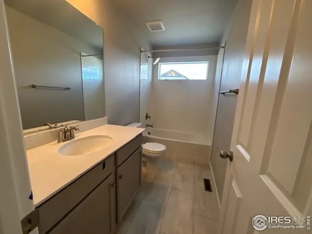 a bathroom with a double vanity sink toilet mirror and shower