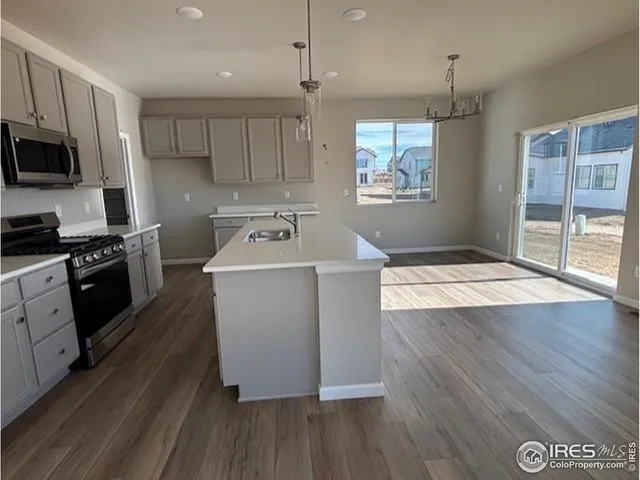 a kitchen with wooden floors and wooden cabinets