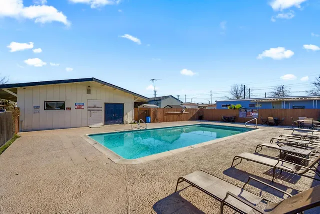 a view of a patio with swimming pool