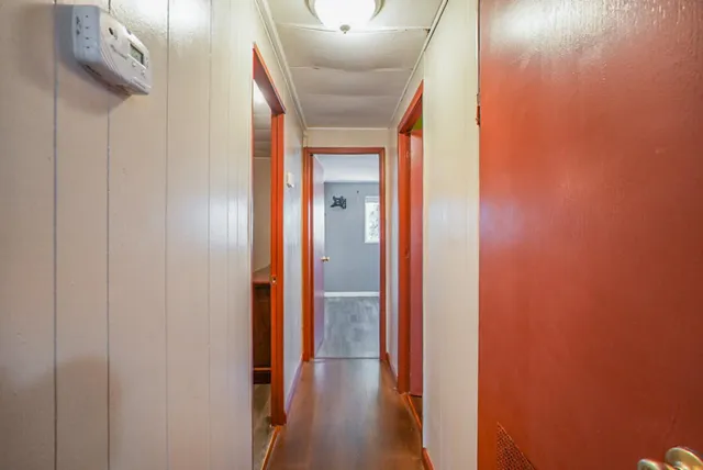 a view of a hallway with wooden floor