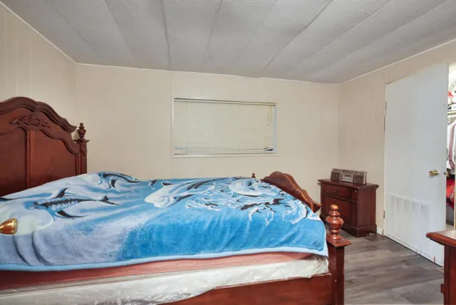 a bedroom with a bed and dresser