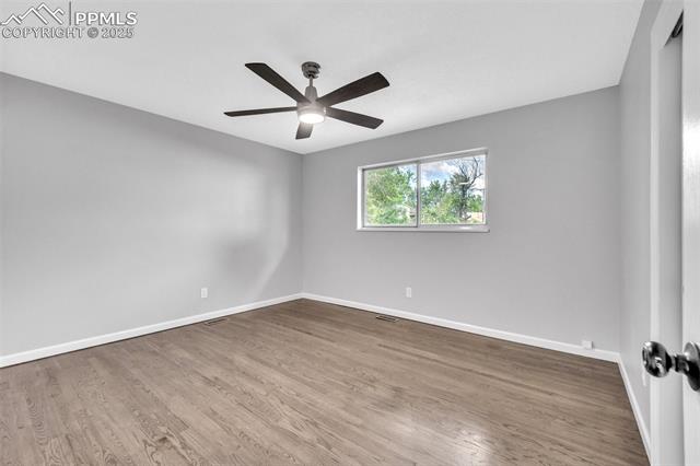 2004 Monterey Road Colorado Springs, CO 80910 - Photo 7 of 27 Spare room with wood finished floors and a ceiling fan