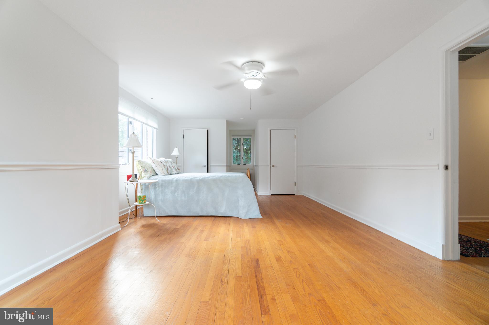 14612 Fairacres Road Silver Spring, MD 20905 - Photo 20 of 53 a bedroom with a bed and a chandelier