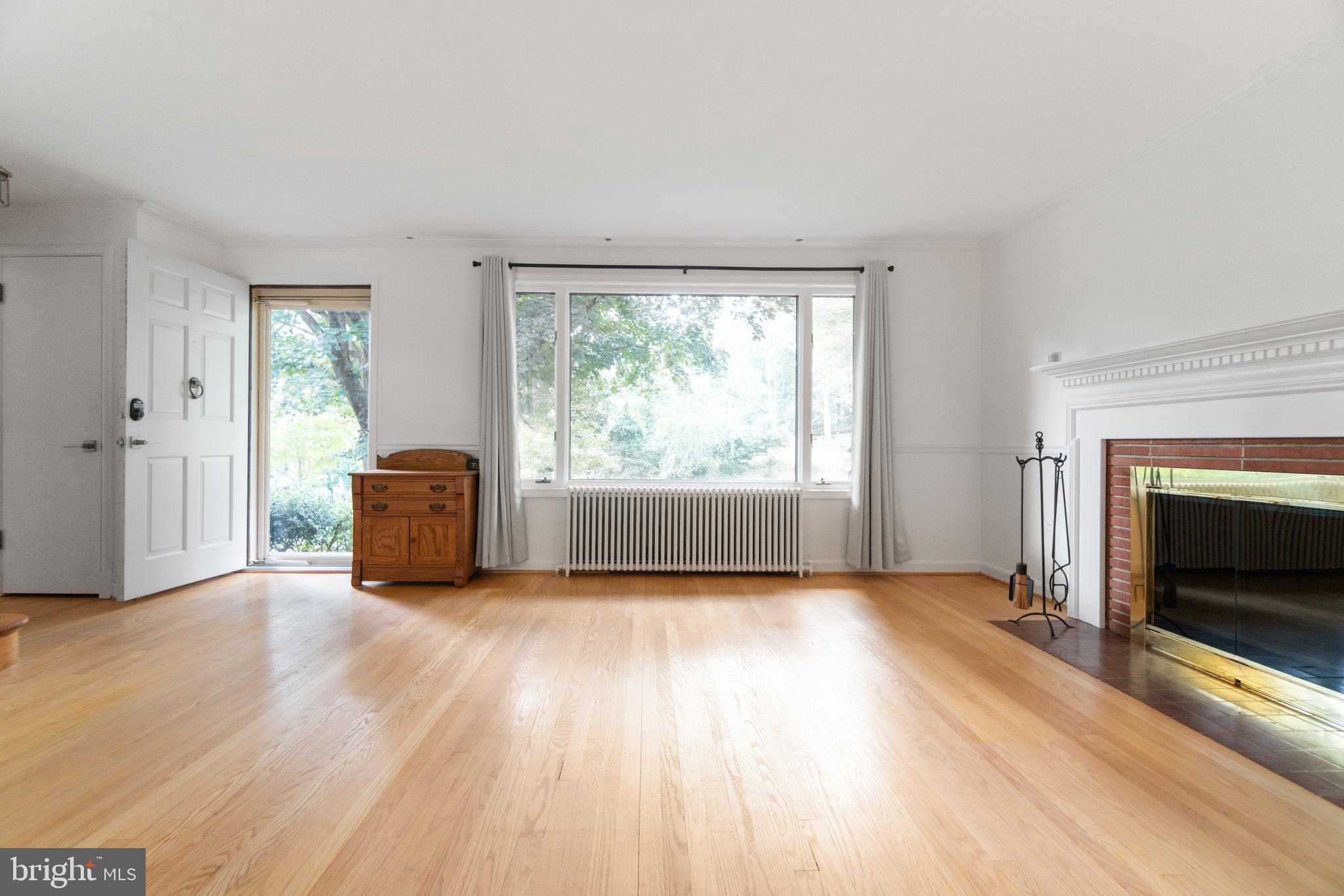 14612 Fairacres Road Silver Spring, MD 20905 - Photo 4 of 53 a view of an empty room with a fireplace and a window