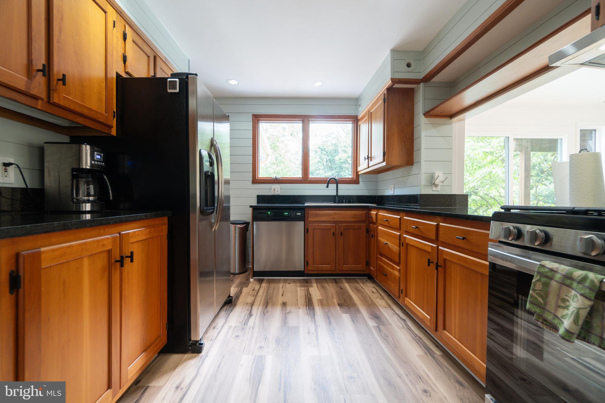 14612 Fairacres Road Silver Spring, MD 20905 - Photo 6 of 53 a kitchen with stainless steel appliances granite countertop white cabinets a refrigerator a sink a stove and a refrigerator